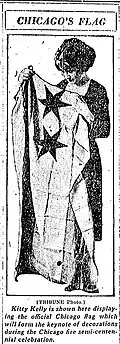 Kitty Kelly holding Flag of Chicago[6] from the Chicago Tribune, 1921. Note the two stars on the flag at the time.