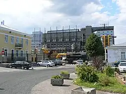A colour photograph of the shale oil facility in Kohtla-Järve. The lower third of the photo is occupied by a curving driveway and the cars parked along it.