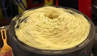 Mung beans being ground to make bindaetteok