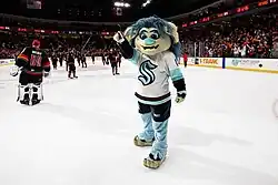 Blue-haired troll wearing a Seattle Kraken hockey jersey