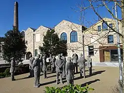 Colour photo showing Kresen Kernow building with trees and statues outside