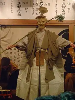 A masked men on stage