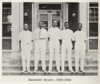 Medical residents posing in front of the hospital.