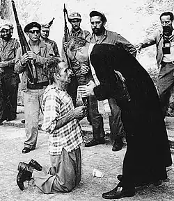 Former corporal Jose Rodriguez, gets last rites from Father Domingo Lorenzo at San Severino Castle. Andrew Lopez received the 1960 Pulitzer Prize for Photography for his execution photos. (January 17, 1959)