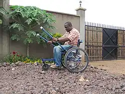 A Leveraged Freedom Chair wheelchair user in Kenya. The chair has been engineered to be low-cost and usable on the rough roads common in developing countries.