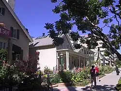Photograph of the Lion House from the sidewalk, with the Beehive House just visible behind.