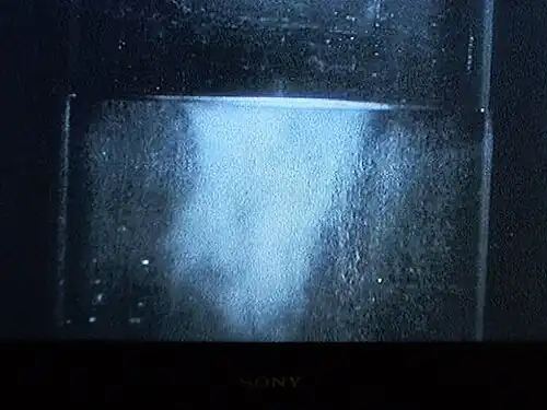 Liquid helium (in a vacuum bottle) at 4.2 K (−268.95 °C) and 1 bar (15 psi) boiling slowly.