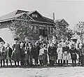 Students and teachers in front of the Little Red Schoolhouse, c. 1910.