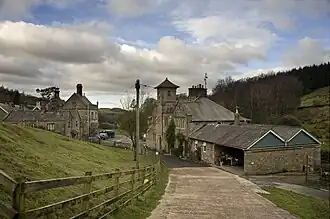 A house including a tower with a pyramidal roof