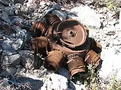 Rusted disk-shaped obviously damaged radial engine lying flat on the ground