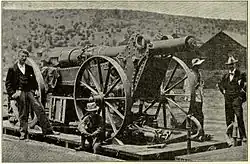 Boer Long Tom gun packed for travel on board a train with the barrel removed from the carriage.
