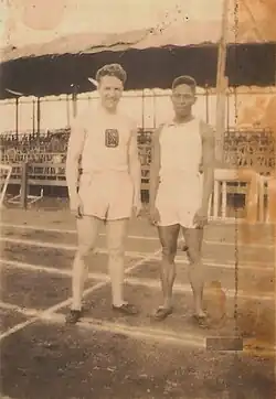 Two athletes in white clothing beside each other