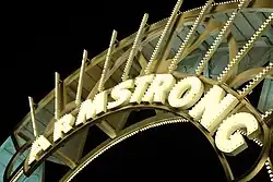 Illuminated gateway arch sign reading "Armstrong"