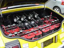 Hydraulic suspension system in the trunk of an Oldsmobile, running 12 batteries and 4 hydraulic pumps. This system is set up for frequent hopping, whereas a lowrider designed for cruising typically uses fewer batteries and pumps.