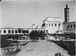 View of the menagerie courtyard in the southwestern corner of the palace, looking north, with the minaret of the Lalla Mina Mosque on the right (photo from 1913)