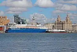 A large cruise ship and smaller high-speed ferry in central Liverpool