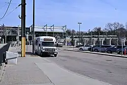 A white minibus stopped at the parking lot at Riverside station