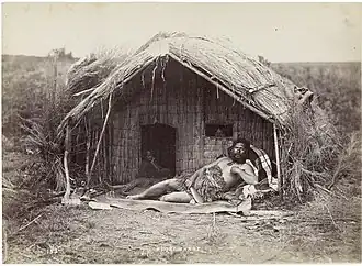 Whare mid 1870s (man at front is the Chief Tahau)