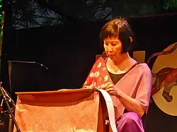 Tan performing on toy piano in 2015