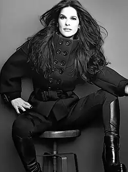 Black-and-white image of Martha Debayle sitting on a chair