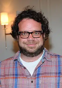 A smiling, bespectacled Christophe Beck