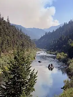 The outline of the fire footprint is shown in orange against the Klamath National Forest in green, west of the communities of Fort Jones, Greenview, and Etna.