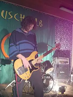 Photo of bassist in grunge attire, 2001.