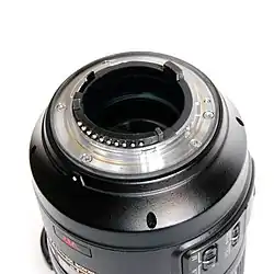The flange of a current F-mount lens, including aperture lever (upper left) and CPU contacts (bottom).