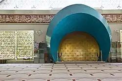 The interior of a modern mosque. The camera is focused on its mihrab.