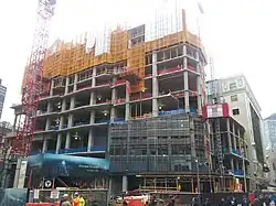 The tower on December 22, 2014 showing the first of the glass paneling.