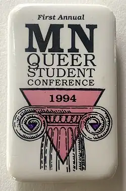 Vertical rectangle Pin Back Button with an illustration of a pink triangle and two purple triangles overlaying the capital of an Ionic column.