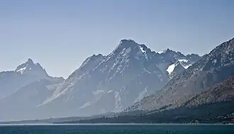 Mount Moran rises abruptly above Jackson Lake. Grand Teton can be seen in the background at left