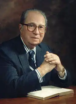 photo of Mortimer Adler sitting by a table