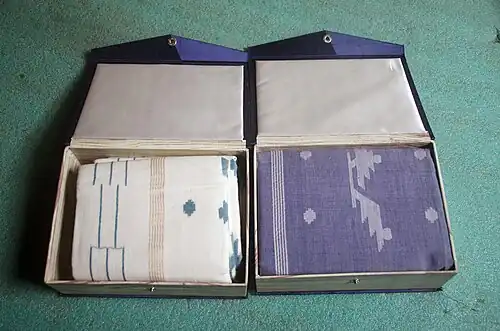 Two muslin sarees packaged in two small cardboard boxes of size approx 8 inches X 6 inches X 2 inches