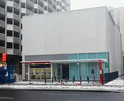 Photo of a largely completed sleek, modern light rail station entrance.