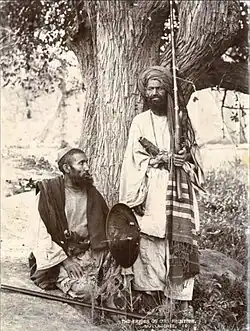 Mullagori tribesmen depicted in 1880, showcasing their traditional attire and weaponry