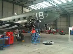 Crews work to solve an oil leak on N1944A prior to departure from England