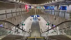 View of the concourse level with the elliptical motif, with an open view of the platform below