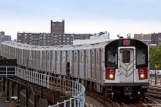 A number 6 train, consisting of R142A train cars, approaching the Parkchester station