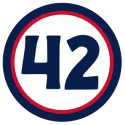 The number "42" in navy blue set against a white circle with a red and navy border