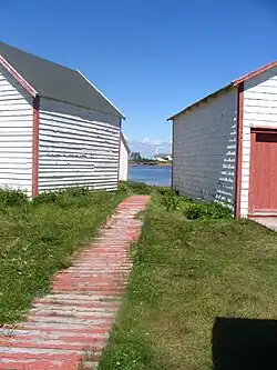 The church view from the wooden sidewalk and stores of the patrimonial site, on the sea shore