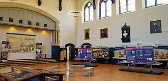 Large gothic hall with several display boards