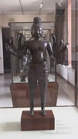 Eight-armed male deity (Maitreya). Provenance Vat Ampil Tok, Kg. Chhnang. 10th century. Bronze with dark patina. Green traces on the feet. H. 75 cm. Inv. 2024. National Museum of Cambodia. Phnom Penh.
