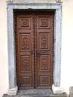 Right side wooden door of the Parish Church of Croveo, Italy, representing the Nativity of Mary