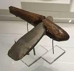 A Neolithic stone axe with a wooden handle