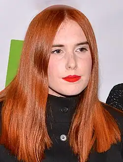 Noonie Bao wearing a black trench coat.