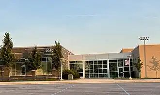 Building section of the front of the high school with brick offices and glass-enclosed walkway