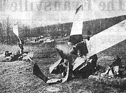 Two badly damaged aircraft propellers propped up on the ground