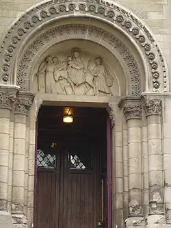 Tympanum of right portal with sculpture of "The flight into Egypt" by Louis Chambard (1811-1891)