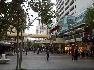 People in a pedestrian mall between buildings
